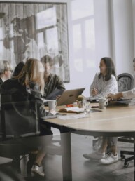 A small group seated around a meeting table — workshops and retreats with Cheryl Donaldson