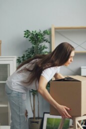 A woman unpacking moving boxes — expat support and transition therapy